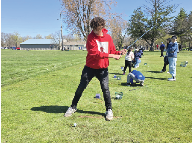 student playing golf
